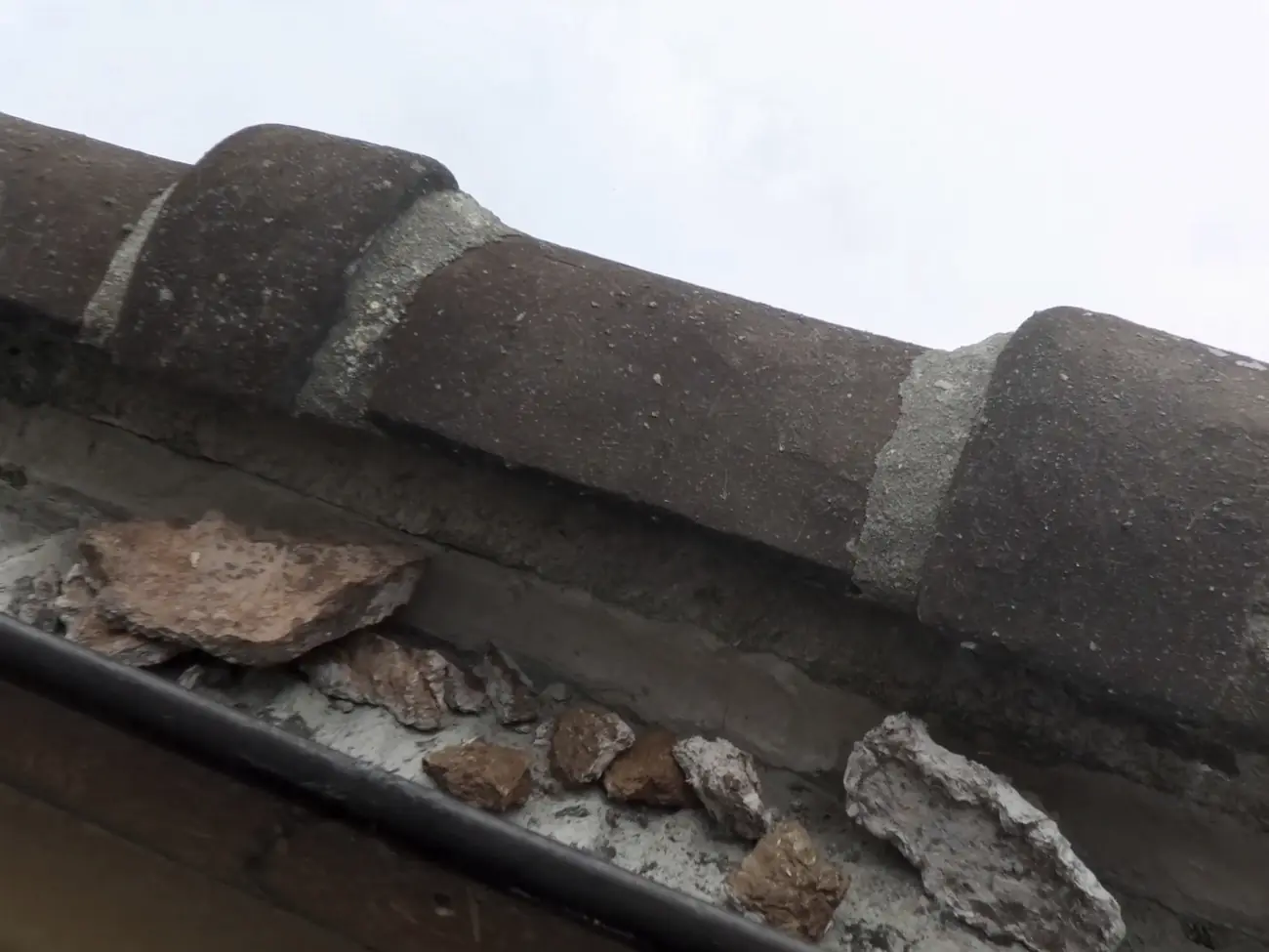 Cracked mortar and a ridge tile lifted out of line after high wind