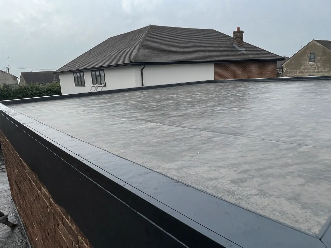 GRP fibreglass flat roof on a rear extension, seamless with a bonded edge trim