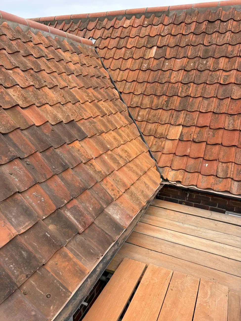 New timber valley boards between clay pantile slopes on a Sheringham re-roof