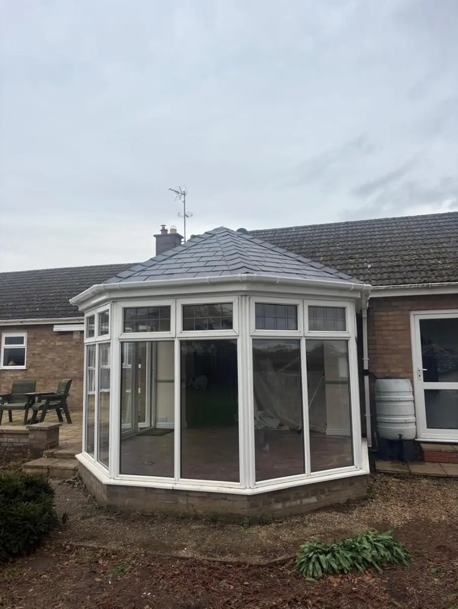 Conservatory finished with a new solid tiled roof in place of the old glazed roof