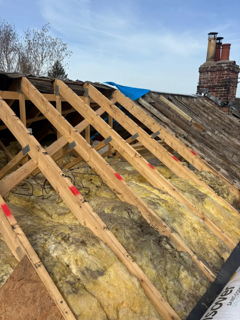 New rafters and insulation exposed during a Suffolk period cottage re-roof