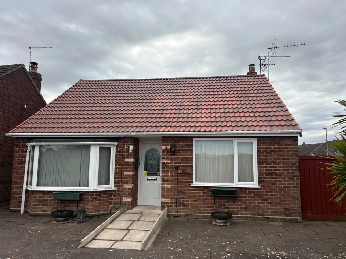 Finished tiled roof on a bungalow, with new ridge tiles and white fascias and guttering