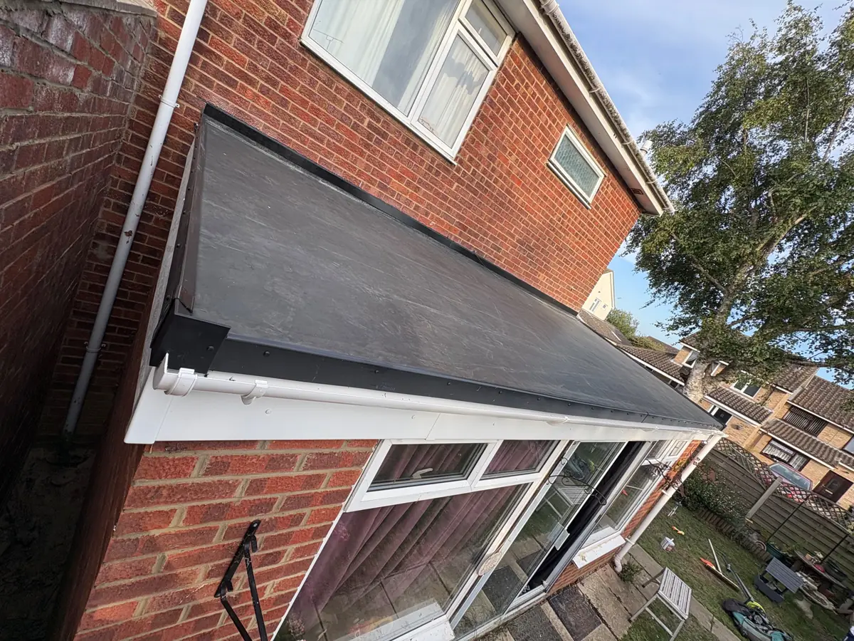 Flat roof on a single-storey rear extension, finished with a dark membrane, edge trim and white fascia