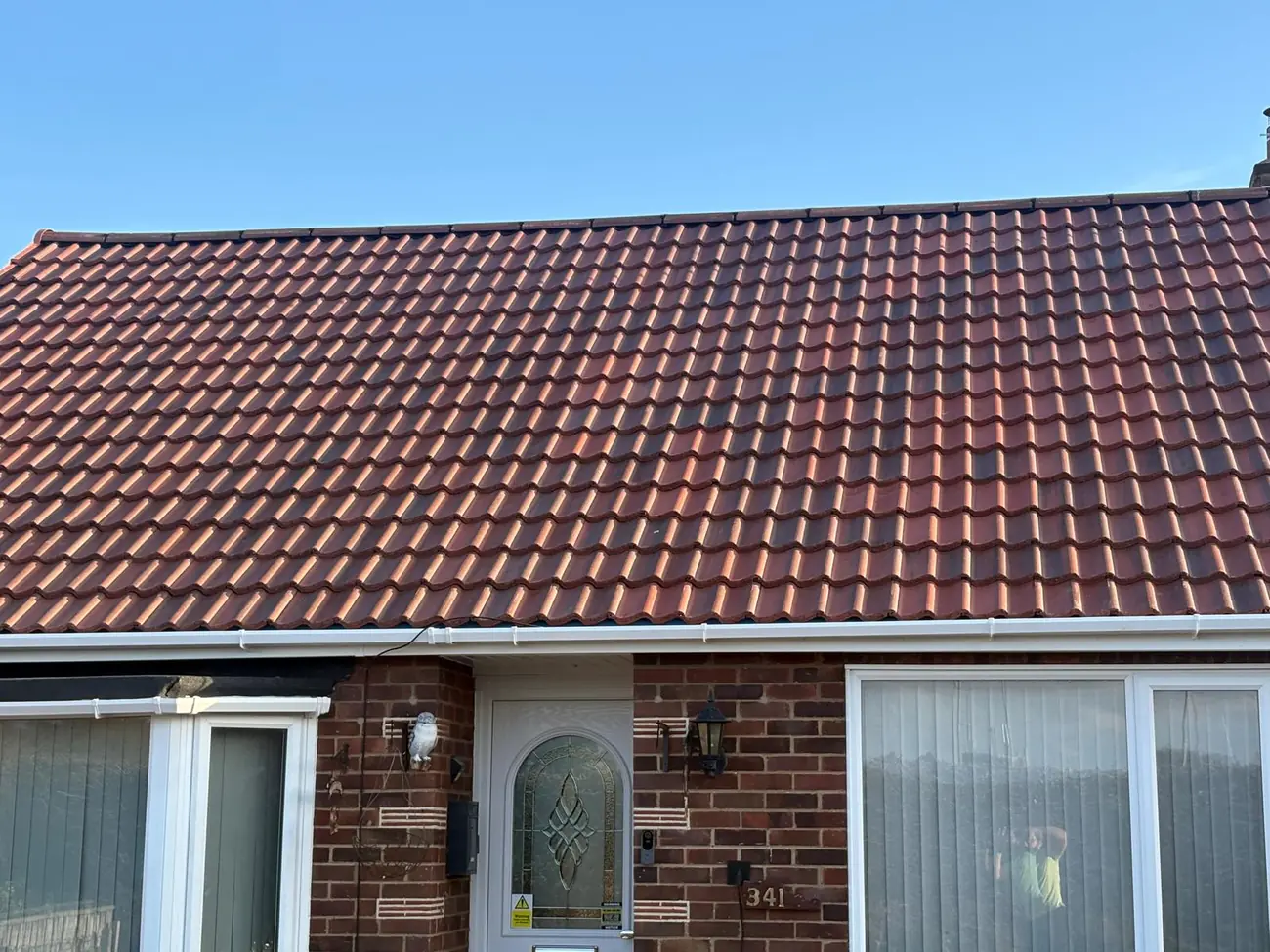 Close view of a completed clay tiled roof and new ridge in Ipswich