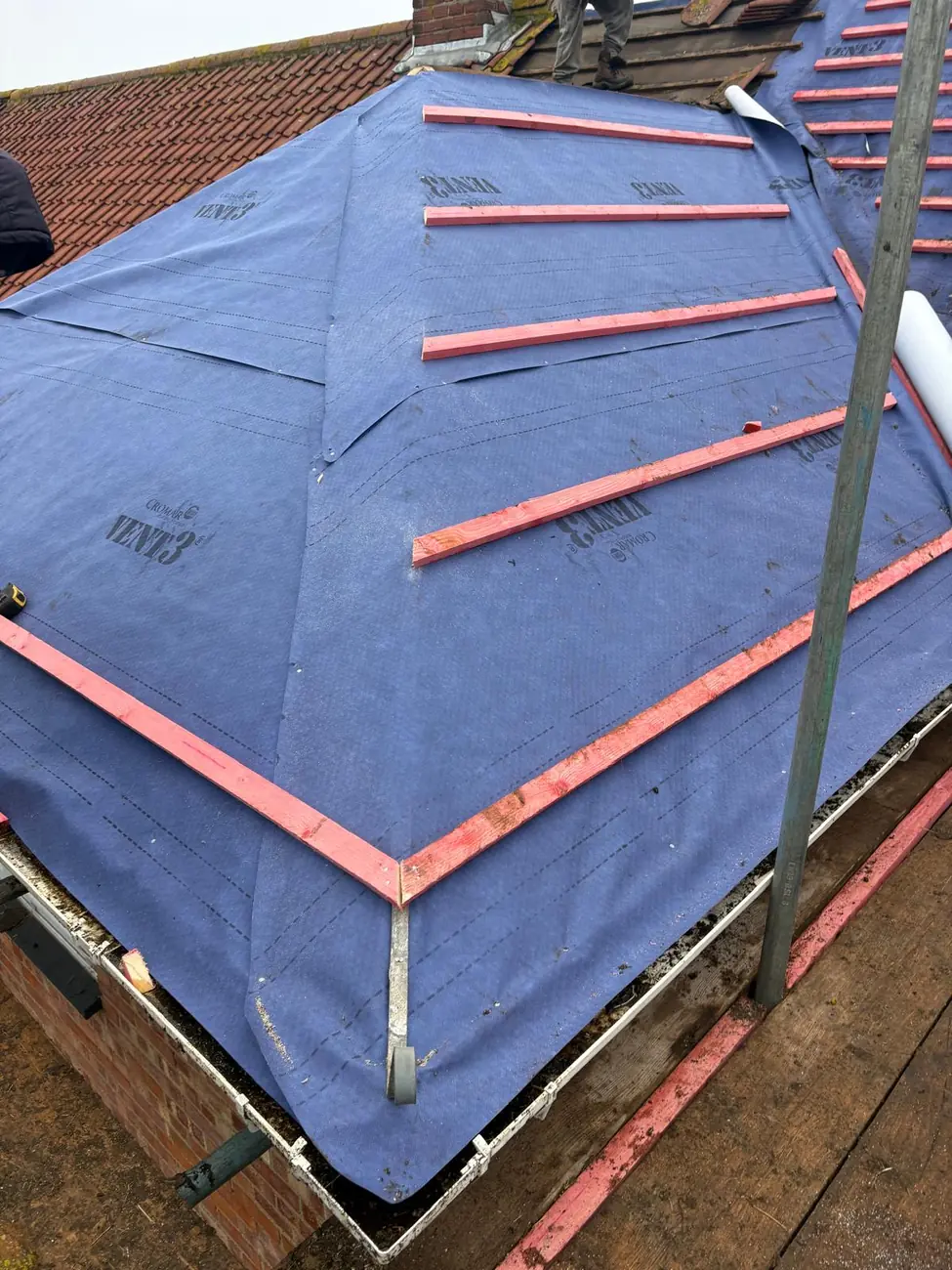 Breathable membrane dressed into the hip with battens gauged ready for tiling, Ipswich