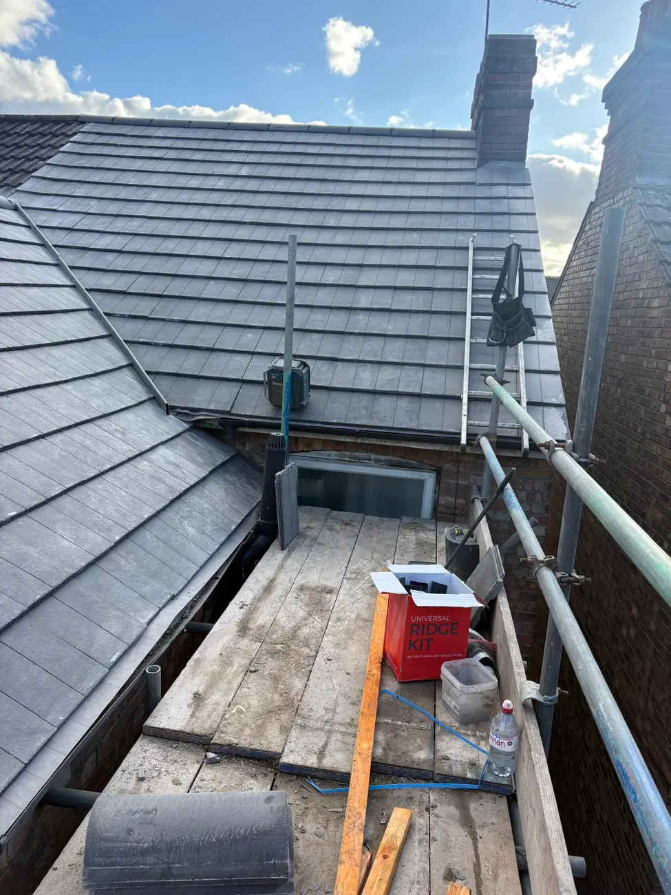 Stormproof roofer working the hip on a re-roof in Diss